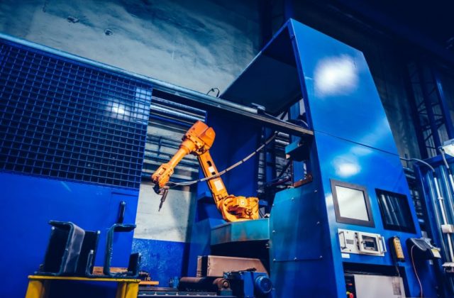 Robotic arm in a factory. Modern heavy industry, machine learning